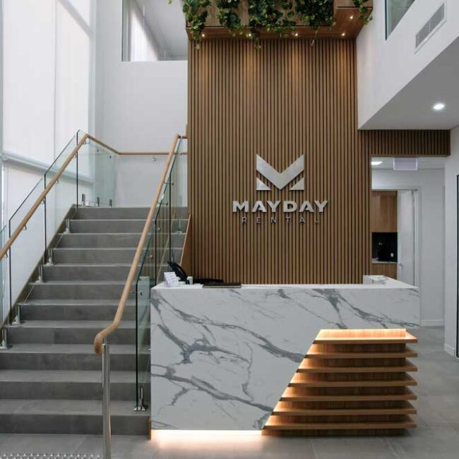 Mayday Rental's new reception desk and stairs leading to office upstairs.